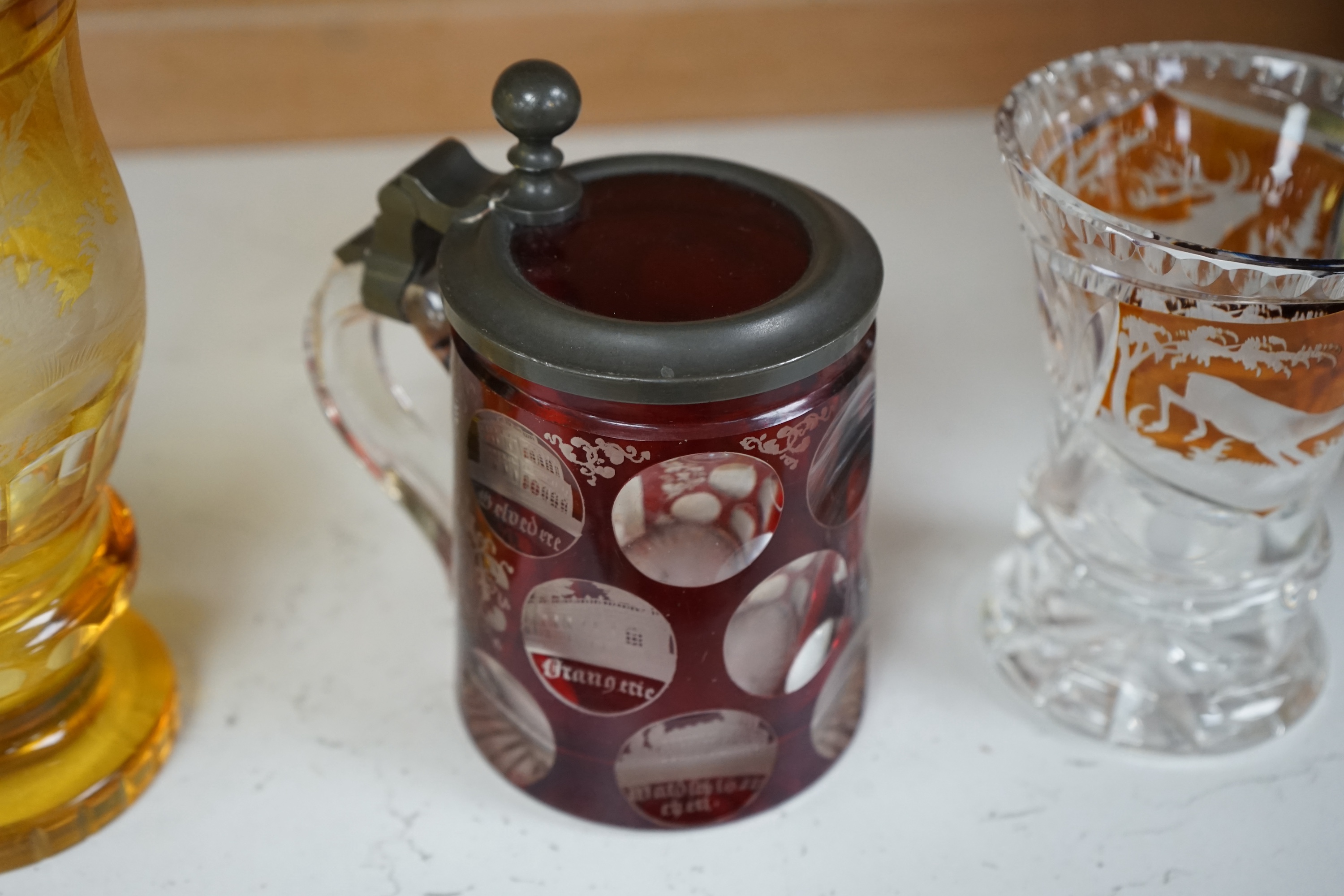 Two 19th century Bohemian glasses and a similar tankard, amber glass 15cm high. Condition - good